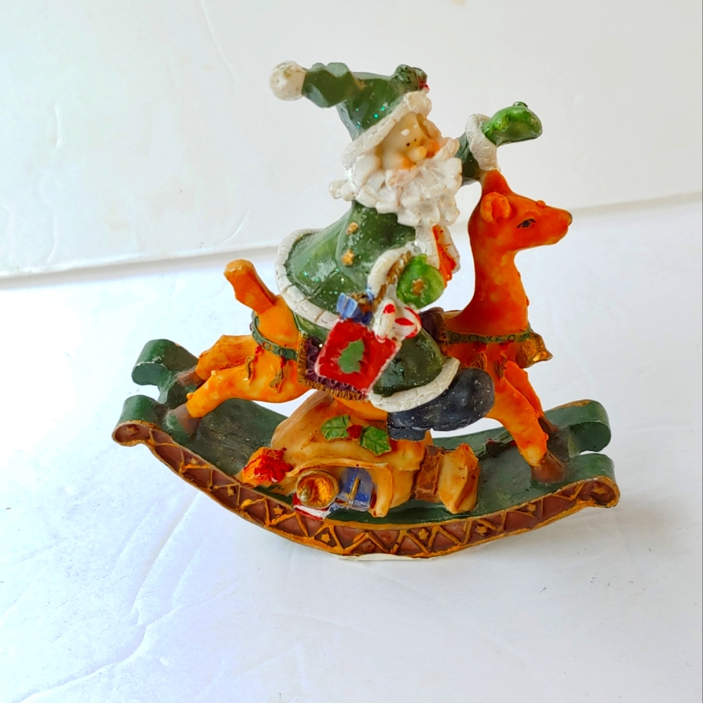 Vintage. Green suitted santa on the rush with toys